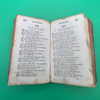 antique German-language hymn book titled Sammlung von Geistlichen Liedern, published in 1858 in Cincinnati.