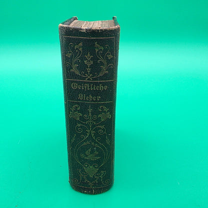 antique German-language hymn book titled Sammlung von Geistlichen Liedern, published in 1858 in Cincinnati.