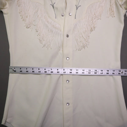 This vintage 1970s H Bar C California Ranchwear "Taos" cream polyester fabric, white fringe detailing, and black and gray floral embroidery with pearl snap