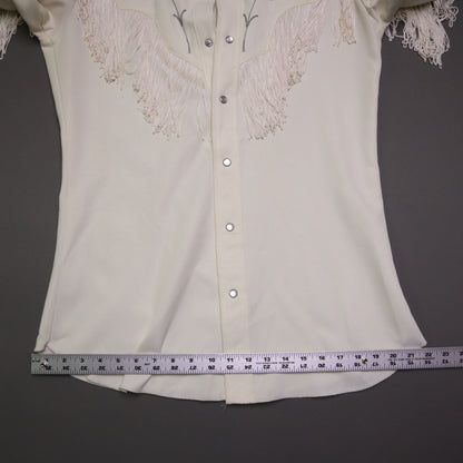 This vintage 1970s H Bar C California Ranchwear "Taos" cream polyester fabric, white fringe detailing, and black and gray floral embroidery with pearl snap