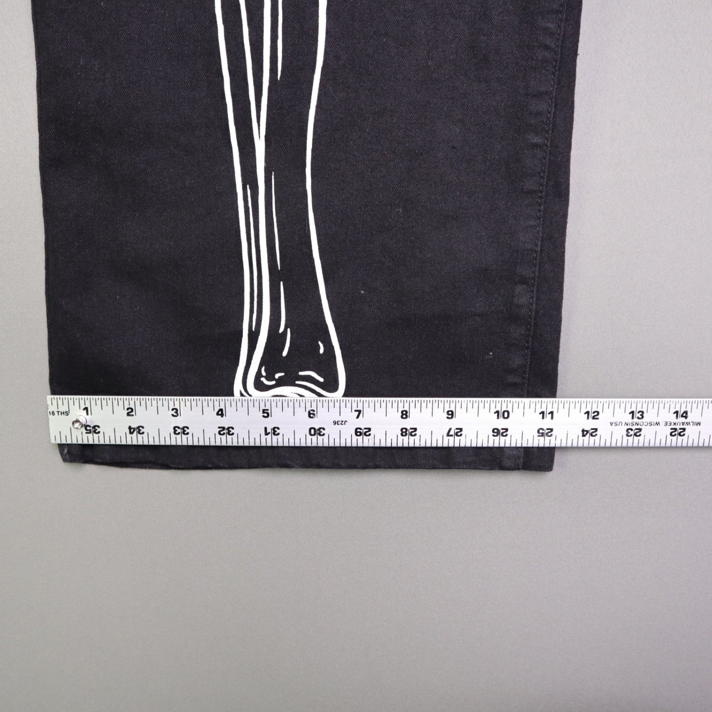 Hot Topic Black Skeleton Outline Wide Leg Pants feature a prominent white pelvic and leg bone print