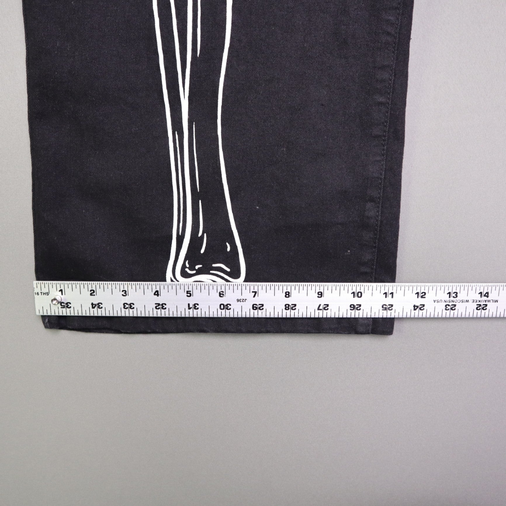 Hot Topic Black Skeleton Outline Wide Leg Pants feature a prominent white pelvic and leg bone print