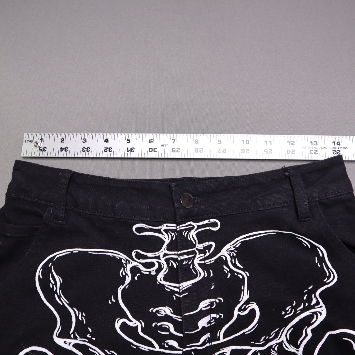 Hot Topic Black Skeleton Outline Wide Leg Pants feature a prominent white pelvic and leg bone print