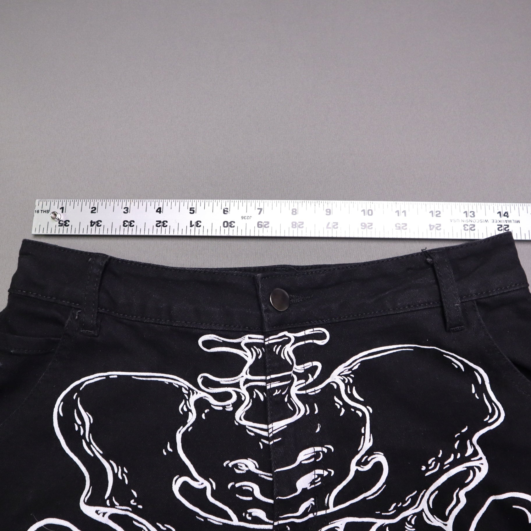 Hot Topic Black Skeleton Outline Wide Leg Pants feature a prominent white pelvic and leg bone print