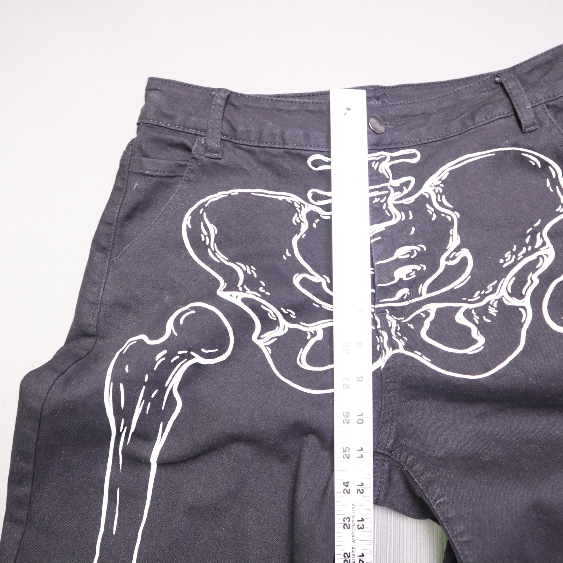 Hot Topic Black Skeleton Outline Wide Leg Pants feature a prominent white pelvic and leg bone print